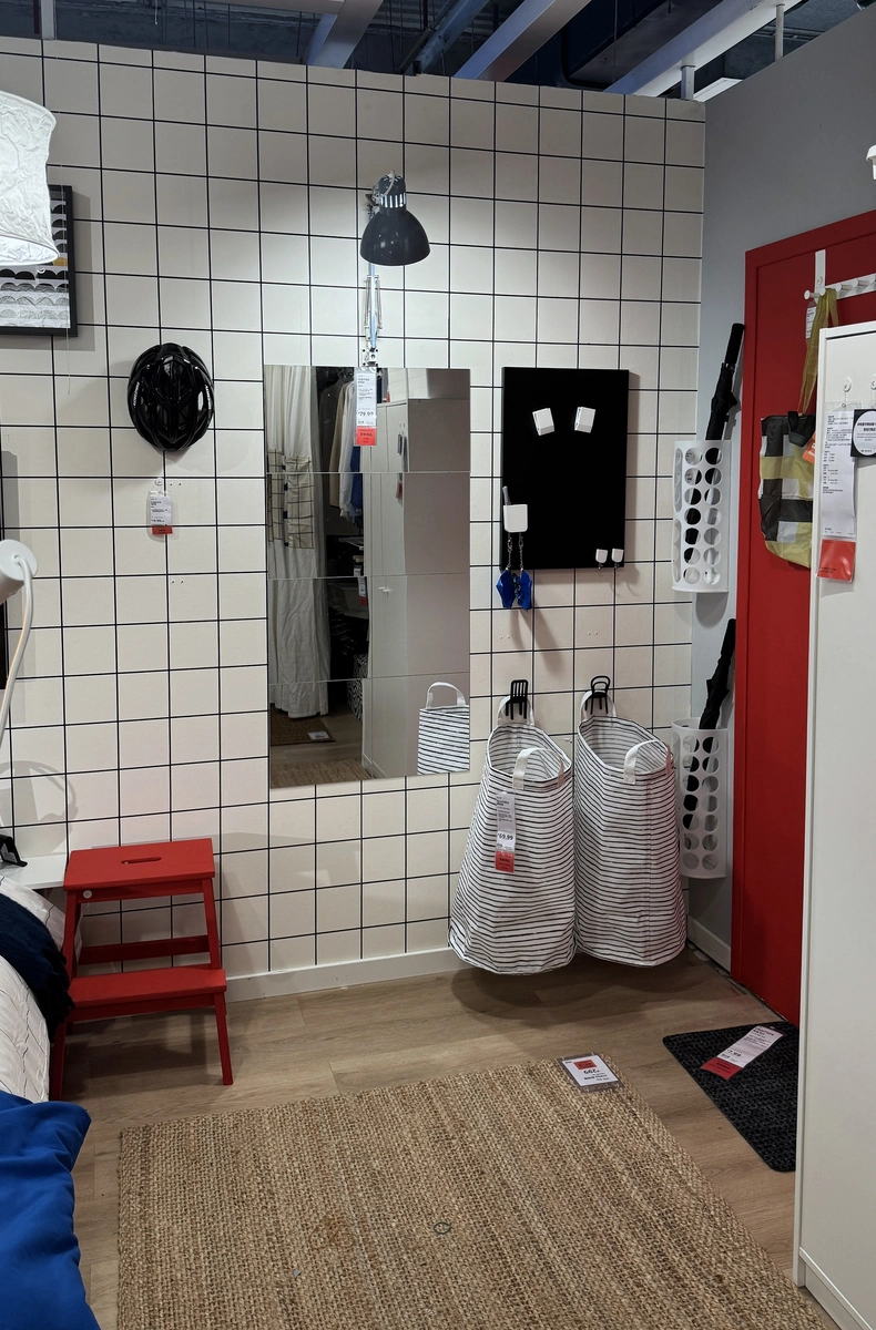 Mirror, pinboard and laundry bags beside the door